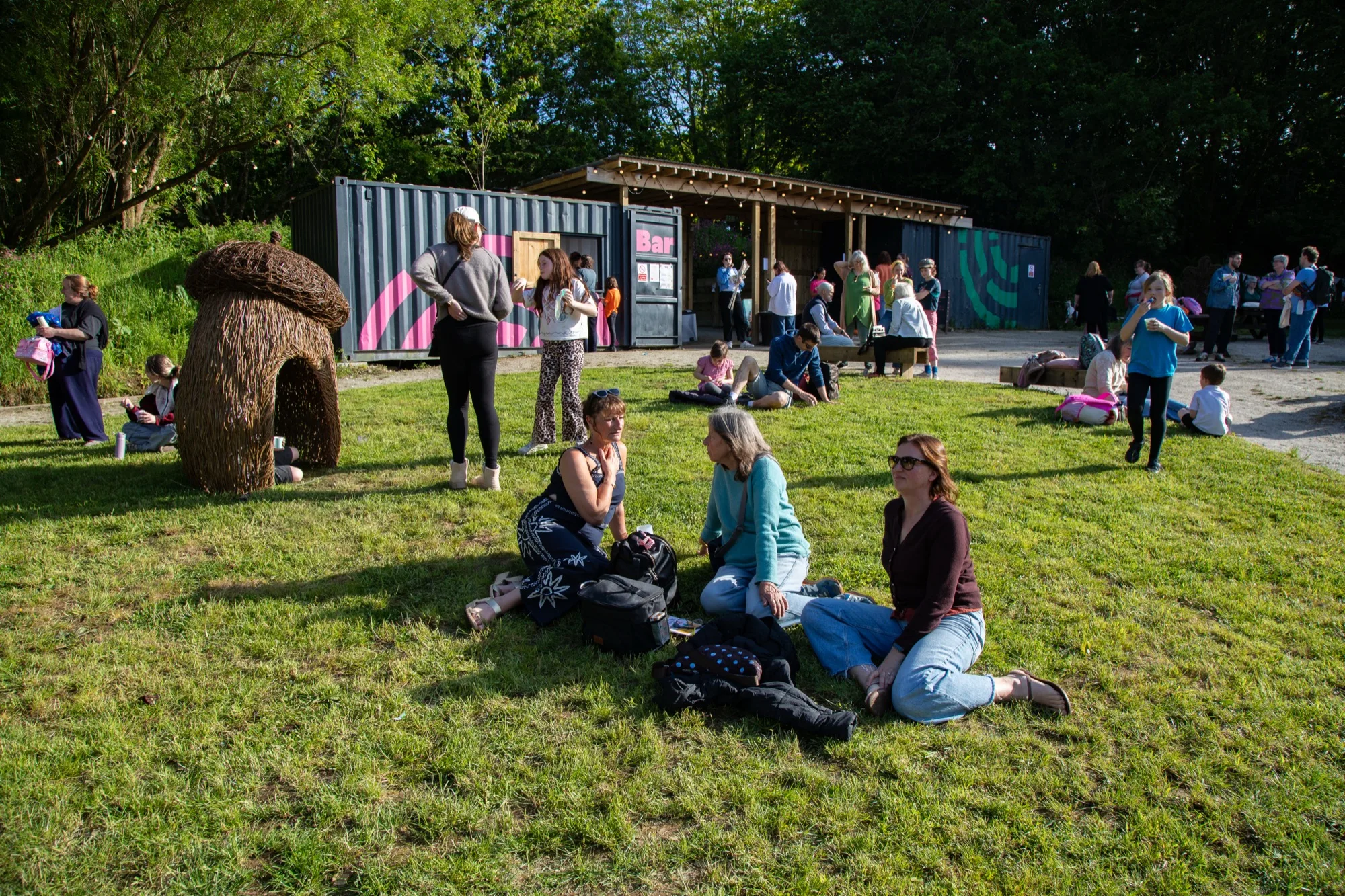 Visitors gathered at the outdoor bar in the evening light
