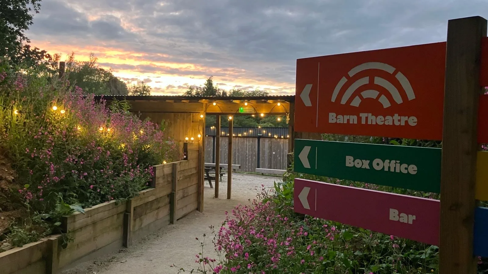 Colourful signage pointing the way to the Barn Theatre, Box Office and Bar